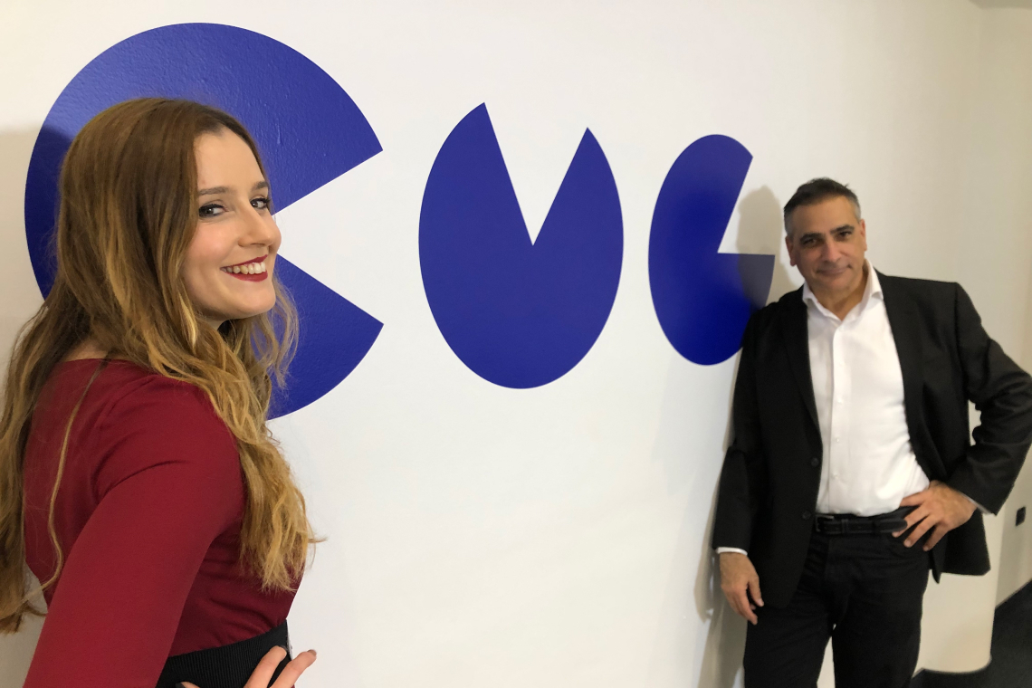 man and woman in front of CMG logo