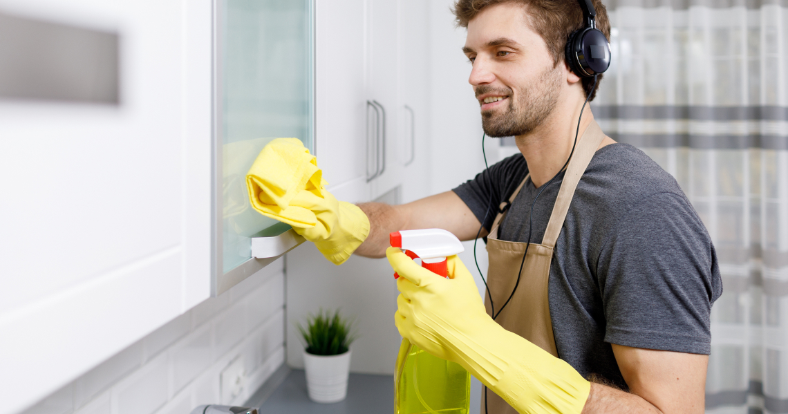man cleaning and listening music