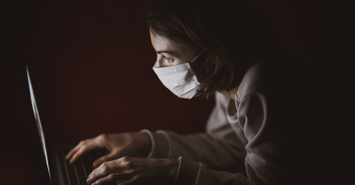 woman on laptop with mask