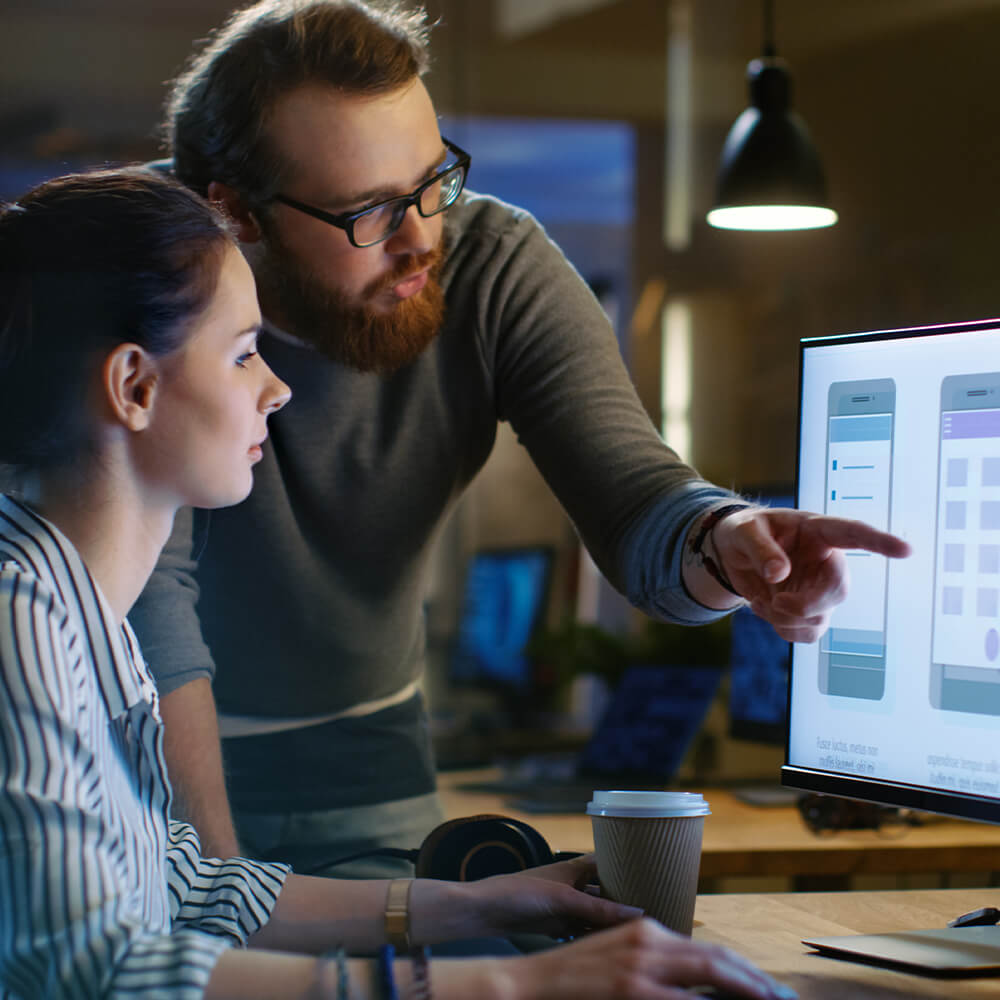 Female UX architect has a discussion with male colleague