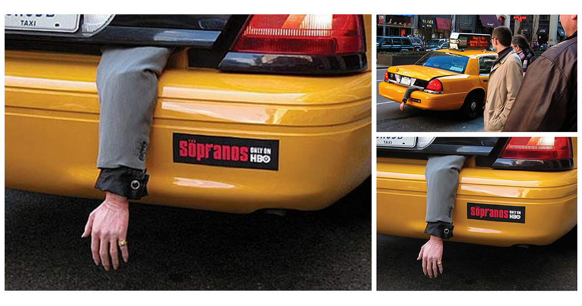 A prop hand hanging out of a yellow taxicab
