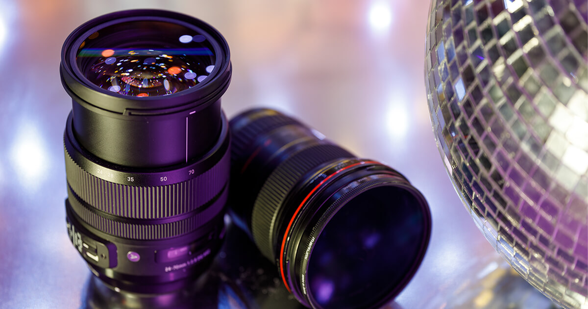 Camera lenses next to a disco ball
