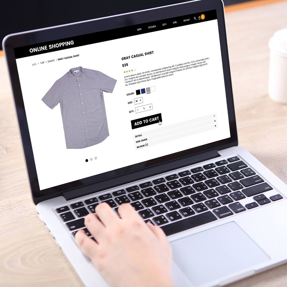 A person browsing an online webshop looking at shirt