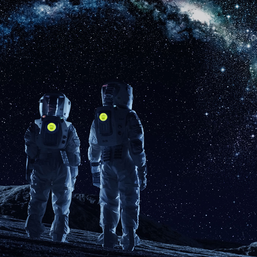 Two astronauts watch milky way standing on the planet in the space